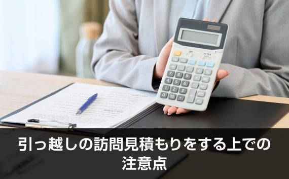 写真：引っ越しの訪問見積もりをする上での注意点。電卓を持っている人が写っている写真。