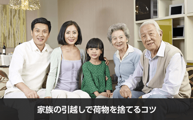 写真：家族の引越しで荷物を捨てるコツ。5人家族が座っている様子の写真。